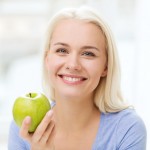 photodune-11711101-happy-woman-eating-green-apple-at-home-s